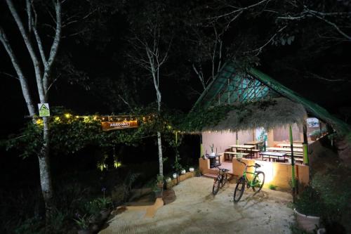 two bikes parked in front of a house at night at Agronest Farm & Resort By Teal Luxury Stay in Wayanad