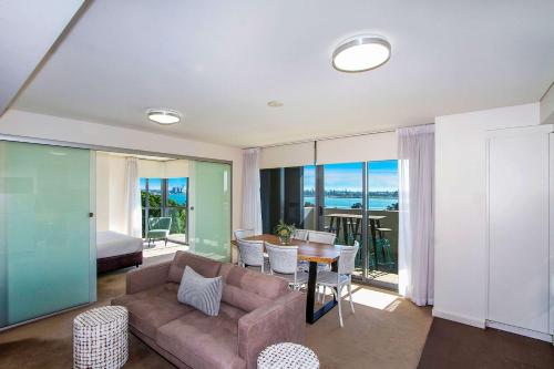 a living room with a couch and a table at Terminus Apartment Hotel, Ascend Hotel Collection in Newcastle