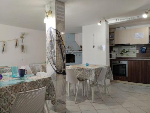 a kitchen with two tables and chairs in a room at Simada Blue Guesthouse in Golden Sands