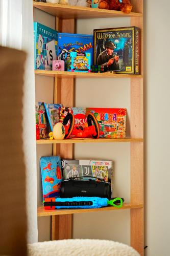 a book shelf filled with toys and games at Villa Vermont Qusar in Qusar