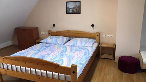 a bedroom with a large bed with a wooden frame at Chalupa Magdaléna in Terchová