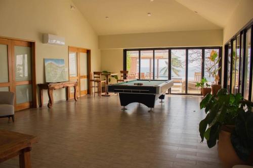 a large room with a pool table in it at Arrue Coastal Escape at Andromeda Pedasi in Loma del Naranjo