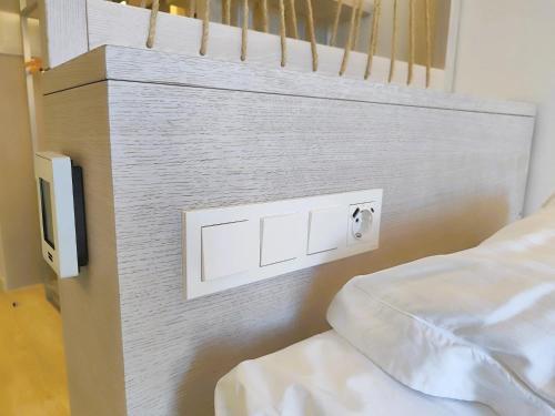 a bedroom with a bed with a wall mounted lightswitch at Valentin Somni Hotel & Suites in Paguera