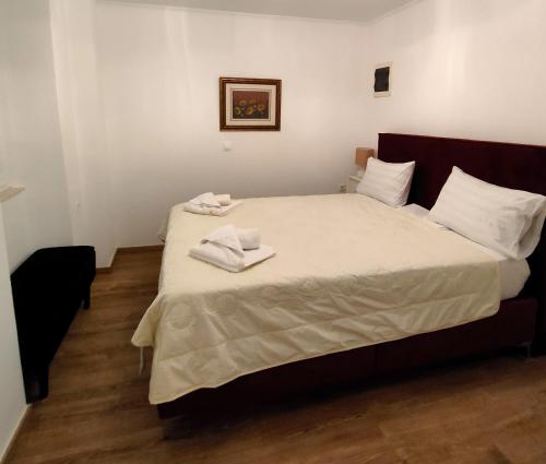 a bedroom with a large bed with towels on it at Casa Contessina in Corfu Town