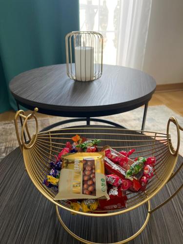 a round table with a basket of candy on a table at Apartman Daria in Vrnjačka Banja