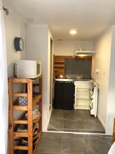 a small kitchen with a microwave and a stove at LA PECHERIE in Saint-Brevin-les-Pins