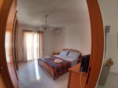 a bedroom with a bed and a mirror at Maison Carmela in Monopoli