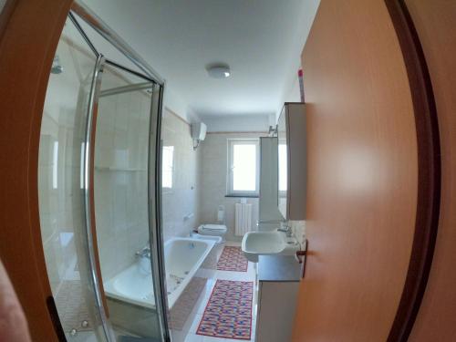 a bathroom with a shower and a sink and a tub at Maison Carmela in Monopoli