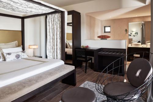 a hotel room with a bed and a desk at Aquagrand Artistic Luxury Beach Resort - Adults Only in Líndos