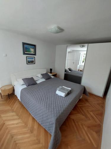 a bedroom with a large bed and a couch at Apartment Ivka in Dubrovnik