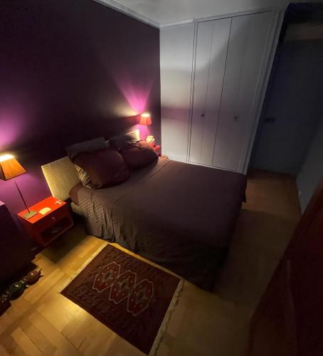 - une chambre avec un lit, deux lampes et un tapis dans l'établissement Chambre d'hôtes au calme, à Paris