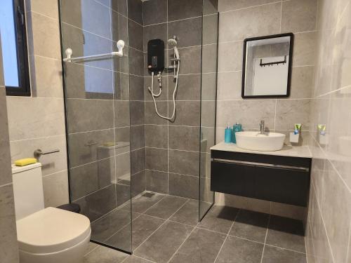 a bathroom with a shower and a toilet and a sink at Antara Lima Homestay Putrajaya in Putrajaya