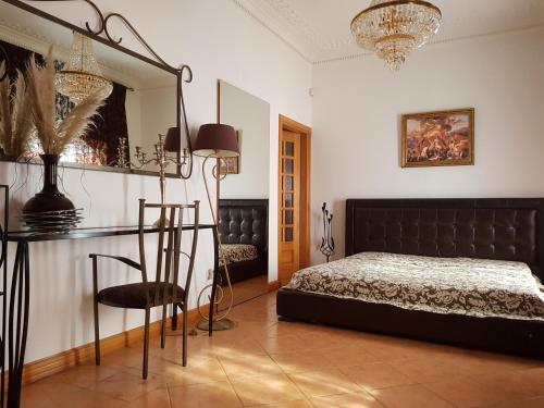 a bedroom with a bed and a table and a mirror at Silver Village Residence in Maceira
