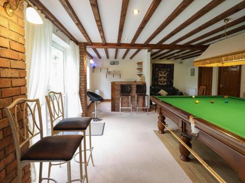 a living room with a pool table at Pengwern in Pennant-Melangell