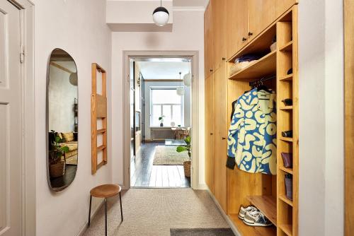 a hallway of a home with wooden shelves at Design district gem, private sauna in Helsinki