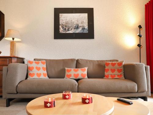 a living room with a couch and a table at Apartment Grand Hôtel A18 by Interhome in Villars-sur-Ollon