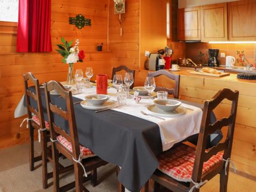 a dining room table with a white table cloth and wine glasses at Apartment Grand Hôtel A18 by Interhome in Villars-sur-Ollon