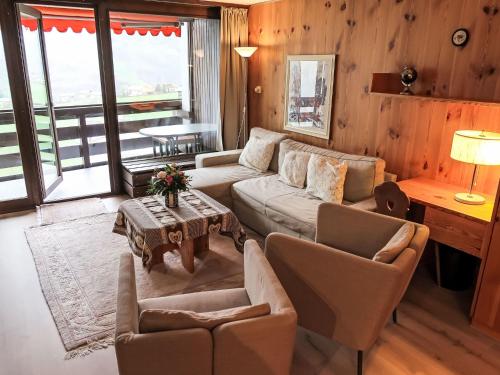 un soggiorno con divano, sedie e tavolo di Apartment Utoring Acletta-125 by Interhome a Disentis