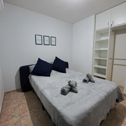 a bedroom with a bed with two stuffed animals on it at Alquiler temporario - NG in Resistencia