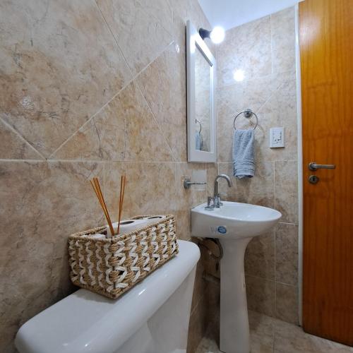 a bathroom with a sink and a toilet and a bath tub at Alquiler temporario - NG in Resistencia