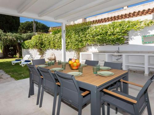 a wooden table and chairs on a patio at Villa Vilafortuny by Interhome in Vilafortuny