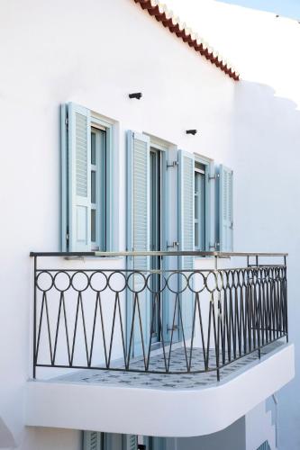 a balcony of a white building with windows at Nerofaoma House in Dhriopís