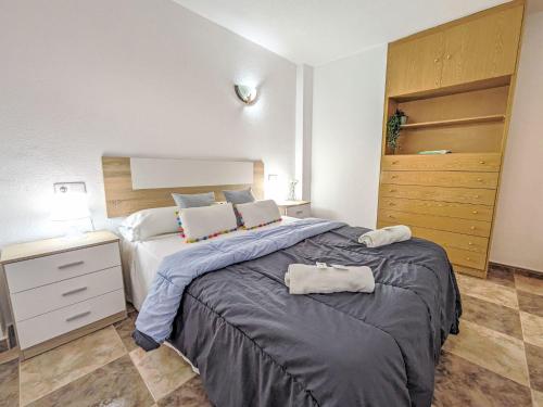 a bedroom with a large bed with two towels on it at Apartment Halcon Levante by Interhome in Benidorm