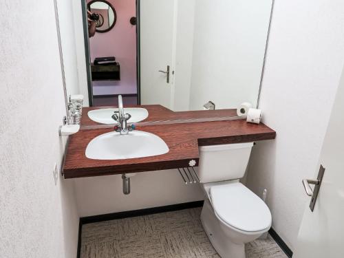 a bathroom with a sink and a toilet at Apartment Apt B 108 by Interhome in Disentis