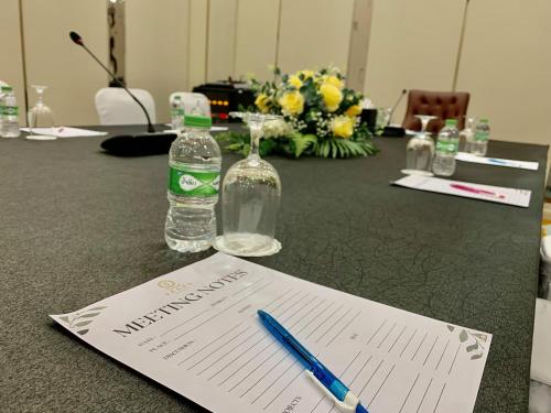 a table with a bottle of water and a pen and paper at ST Vegas Hotel in Ban Nong-Heo