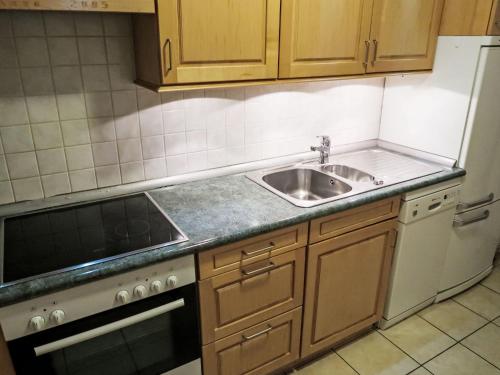 a small kitchen with a sink and a stove at Apartment Apt B 048 by Interhome in Disentis