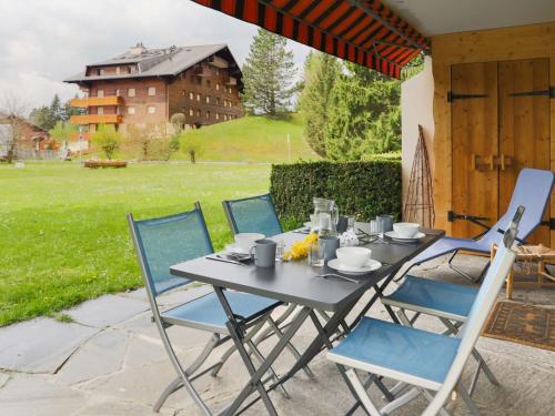 a table and chairs sitting on a patio at Apartment Diamant 6 by Interhome in Villars-sur-Ollon
