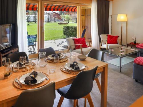 a living room with a wooden table and chairs at Apartment Diamant 6 by Interhome in Villars-sur-Ollon