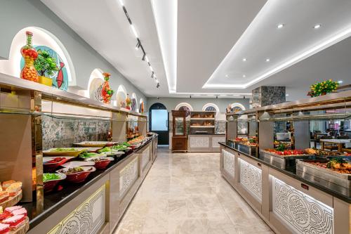 a buffet line with many different types of food at Club Big Blue Suit Hotel - All Inclusive Plus in Alanya