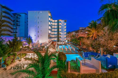 a resort with a swimming pool at night at Club Big Blue Suit Hotel - All Inclusive in Alanya