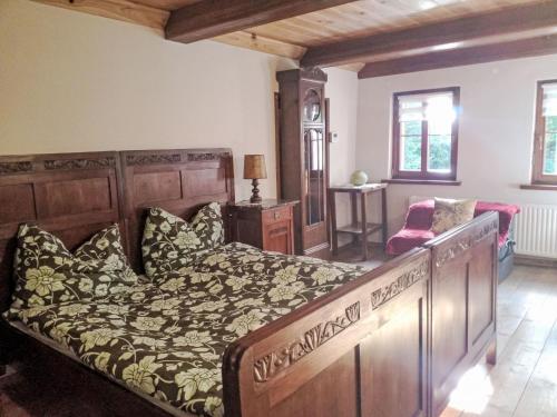 a bedroom with a large bed with a wooden headboard at Holiday Home Karpacz Kowary by Interhome in Kowary
