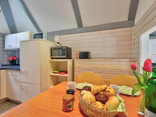 a kitchen with a table with a basket of food at Holiday Home Dorf 1-Haus 14 by Interhome in Kirchheim