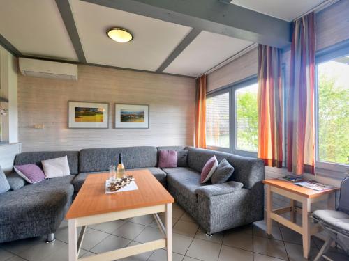 uma sala de estar com um sofá e uma mesa em Holiday Home Seepark Kirchheim-7 by Interhome em Kirchheim