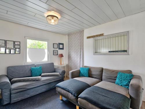 a living room with two couches and a couch at Holiday Home Dorf 4-Haus 10 by Interhome in Kirchheim