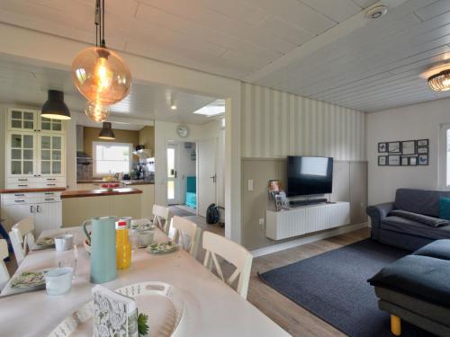 a kitchen and living room with a table and a couch at Holiday Home Dorf 4-Haus 10 by Interhome in Kirchheim