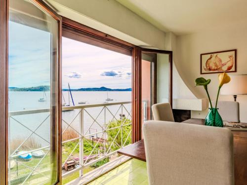 a room with a large window with a view of the water at Apartment Casa sul lago di Lea by Interhome in  Monvalle 