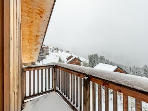 a balcony of a cabin with snow on it at Chalet Klippitzoase by Interhome in Klippitztorl