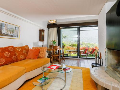 a living room with a couch and a fireplace at Apartment Villaggio Sureggio A3 mit TicinoTicket by Interhome in Lugaggia