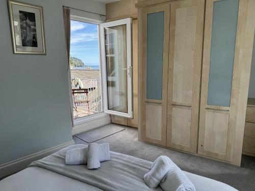 a bedroom with a bed and a view of the ocean at Seascape - Waterfront apartment, glorious views and parking in Dartmouth