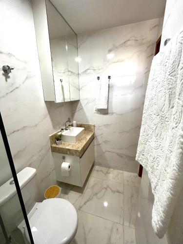 a white bathroom with a sink and a toilet at Flat Sand Beach-IntermaresPB in Cabedelo