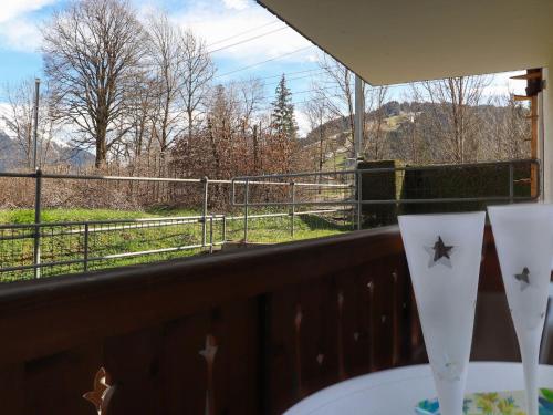 a balcony with a table with a view of a field at Apartment Marie-Soleil Est by Interhome in Gstaad