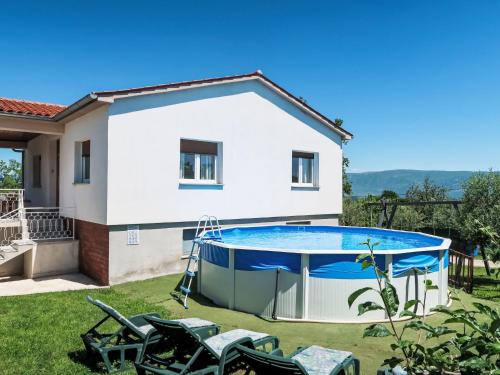 a house with a swimming pool in a yard at Holiday Home Laura by Interhome in Potpićan