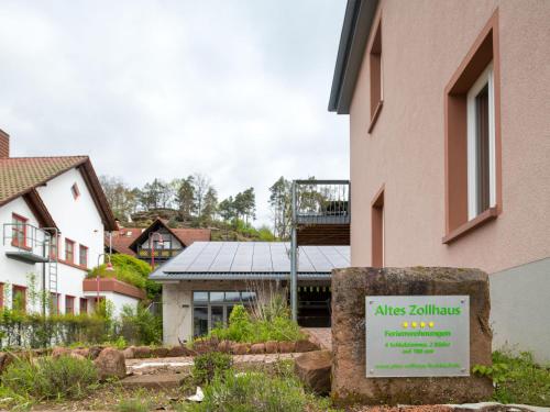 a building with a sign in front of it at Apartment Altes Zollhaus-1 by Interhome in Fischbach bei Dahn