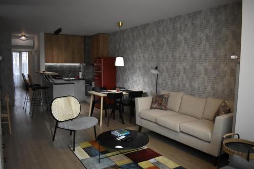 a living room with a couch and a kitchen at Vienna A lovely two bedrooms apartment with parking in Sofia