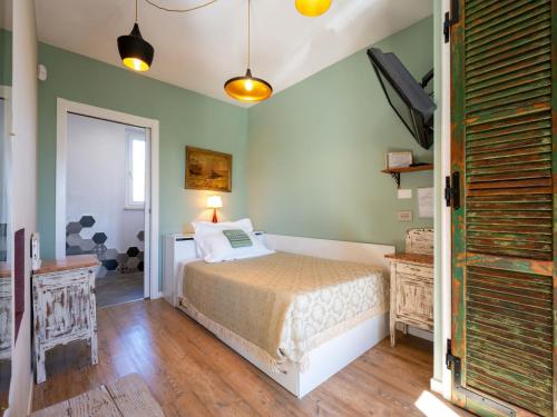 a bedroom with a bed and a tv in it at Holiday Home Helix1912 by Interhome in San Damiano dʼAsti
