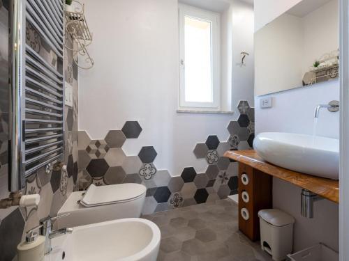 a bathroom with a toilet and a sink at Holiday Home Helix1912 by Interhome in San Damiano dʼAsti